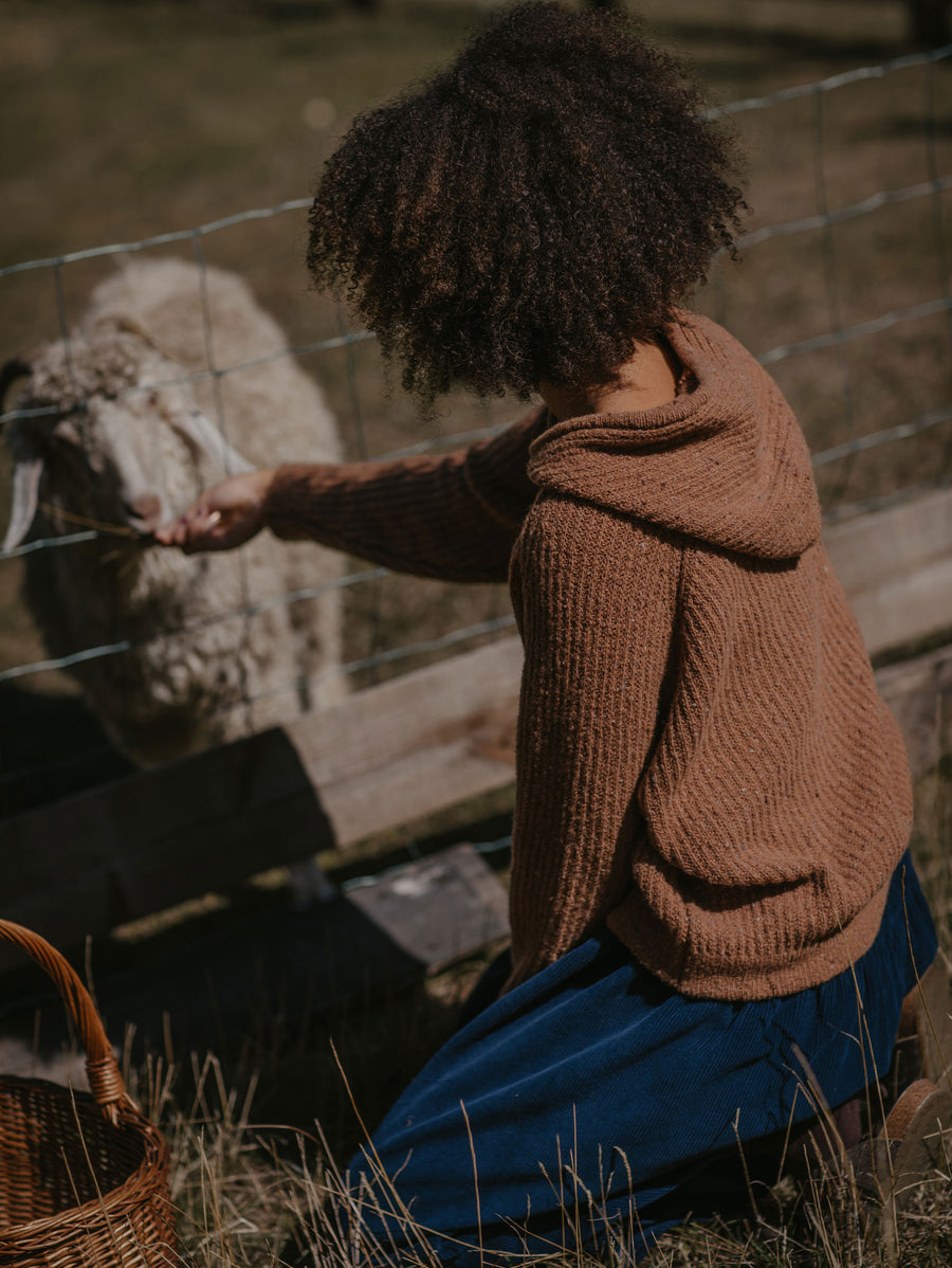 Jaye is 5ft 6in/167cm and is wearing The Knit Hoodie in Maple, size S.